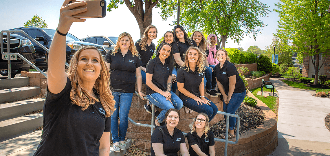 NMC ambassadors gather together on campus to take a selfie